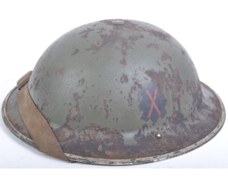 An original WWII Second World War British Army BEF steel Brodie helmet. The helmet of usual form with green paintwork, black 