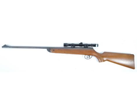 An original vintage BSA made Meteor .22 calibre air rifle, fitted with a Gunmark 4x20 scope. Wooden stick, with maker's marks