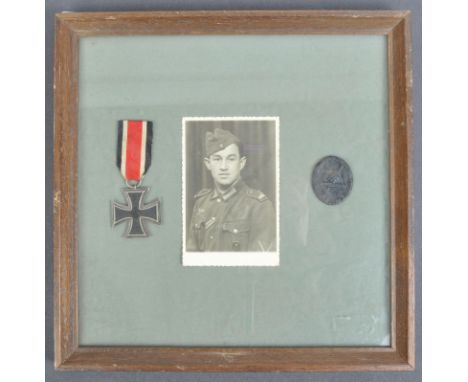 An original WWII Second World War Third Reich Nazi German soldiers Iron Cross, Wound badge and portrait. The Iron Cross being