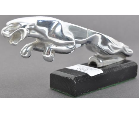 A vintage Jaguar car chrome metal car bonnet emblem / mascot of the iconic leaping cat. Mounted to a black wooden base. Some 