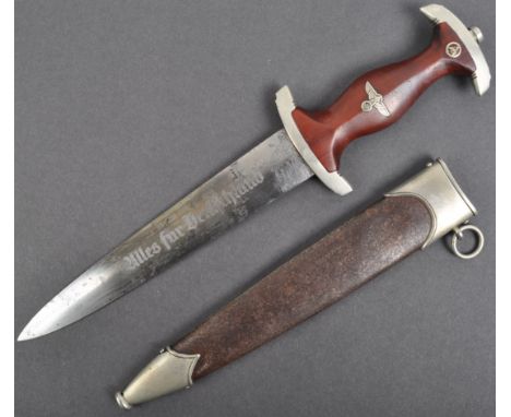 An original WWII Second World War German Nazi Third Reich NSKK  ' SA ' dagger. Having a shaped wooden grip with inset SA roun