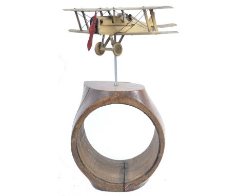 A WWI First World War Royal Flying Corps RFC interest tinplate model of a British fighter plane, mounted atop an original vin