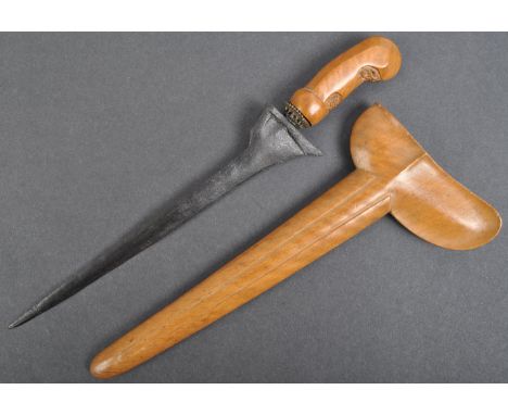 An early 20th century Indonesian / Balinese Kris dagger. The dagger of typical form, with a carved hardwood handle and set wi