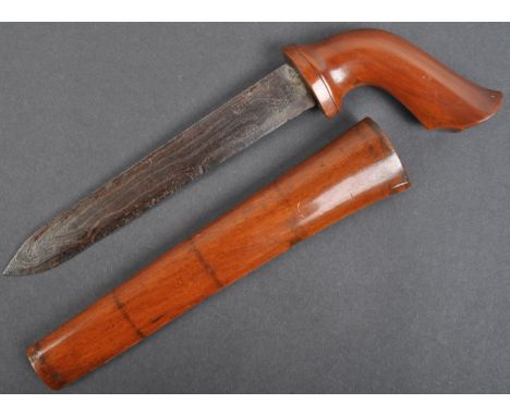 An antique late 19th / early 20th century Malayan Parang dagger. Carved hardwood handle, with a double edged Damascus steel b