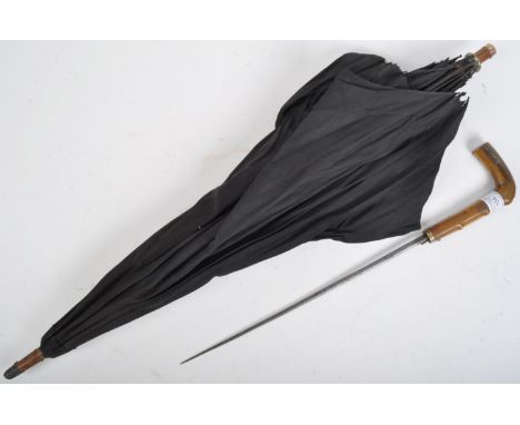 An interesting 19th Century Victorian parasol umbrella sword stick with concealed blade. The parasol having a hook shaped hor