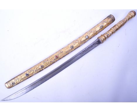 A 20th Century ornamental South East Asian / Burmese ceremonial Dha sword. The sword having a carved wooden handle and matchi