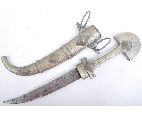 A 20th century Middle Eastern Moroccan Jambiya ceremonial dagger. Crescent white metal decorated grip leading to a small curv