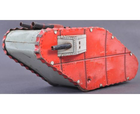 An antique German made clockwork tinplate model of a WWI First World War British tank. The tank with clockwork mechanism driv
