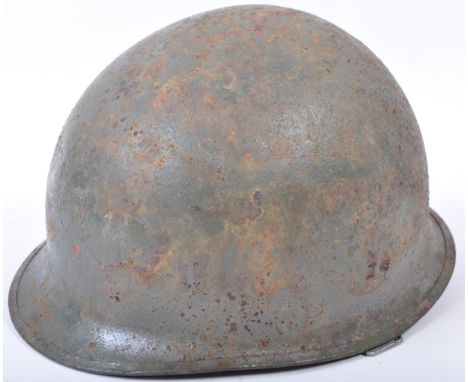 An original WWII Second World War US American Army M1 combat helmet. The steel helmet having a hard hat-like liner that&nbsp;