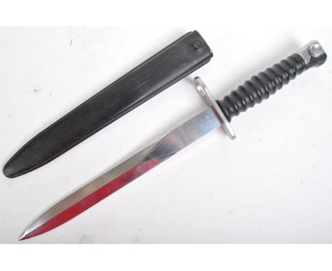 An original 20th Century Swiss 1957 pattern S.I.G rifle bayonet. Steel push release button to the pommel, rubbed plastic grip