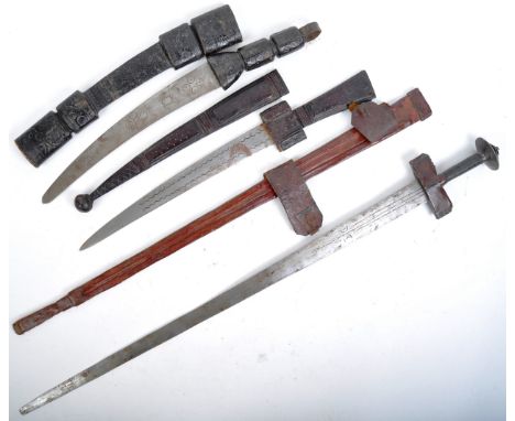 A collection of x3 believed antique tribal / ethnic swords and daggers comprising a Sudanic Takouba sword with long double ed