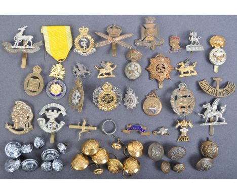A large collection of assorted WWII Second World War and later British Army officers uniform cap badges and tunic buttons fro