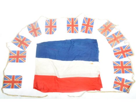 A collection of original WWII Second World War likely VE Day celebration flags / bunting. Including a long section of red, wh