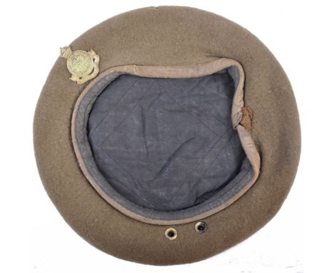 An original 20th century post-WWII Second World War 1949 dated British Army uniform beret, with an associated cap badge to fr