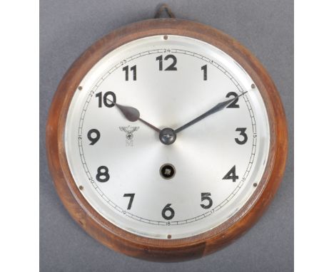 An original WWII Second World War Third Reich Nazi German wall mounted Marine clock. The clock depicting the eagle and Swasti