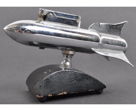 A WWII Second World War interest mid-20th century Art Deco style chrome desktop cigarette lighter in the form of a bomb or ro