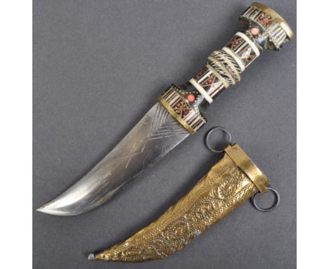 An antique late 19th / early 20th century Islamic / Arabic Jambiya dagger. The handle profusely decorated with brass and bone