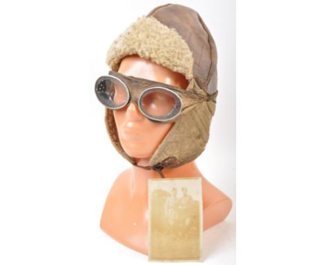 A WWI First World War period RAF / RFC Royal Flying Corps related pilot's flying helmet and goggles. The helmet of leather co