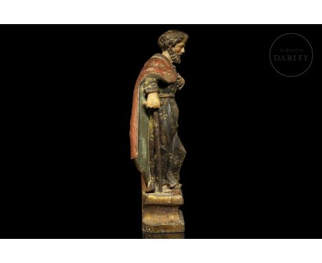 Sculpture in carved, polychromed and gilded wood. The figure stands on a pedestal with reliefs and holds a staff in his right