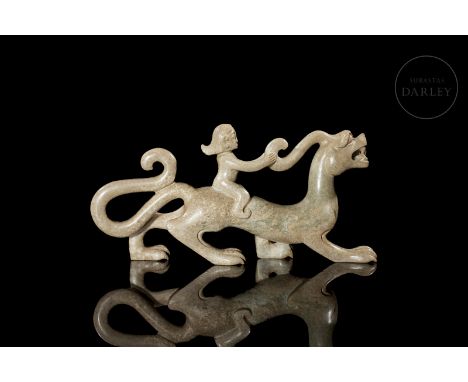 Carved jade, light in tone with ochre and reddish flecks. It shows an elegant dragon, with a slender, elongated body, its rig