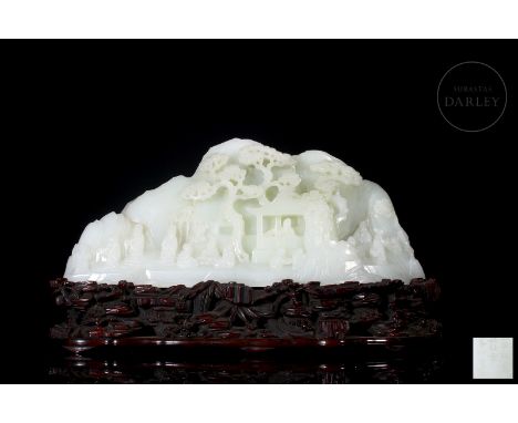 Carved jade, pristine white and smooth in texture. It depicts a large, craggy mountain, on which multiple figures in traditio