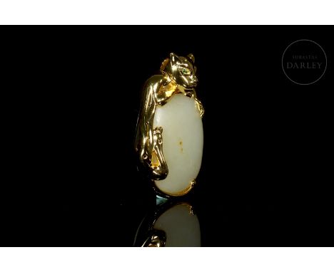 White carved jade, with subtle reddish flecks. It has an oval shape and a smooth, soft surface. It is framed by a later silve
