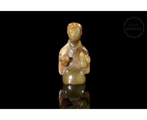 Carved jade of a greenish hue with brownish and ochre stains. It depicts a young maid kneeling, holding a small teapot and cu
