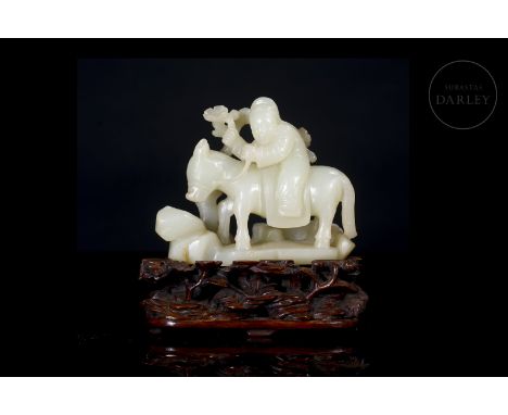 Carved white jade, with a creamy hue and a smooth finish punctuated by subtle gold flecks. It depicts an image of an old man 
