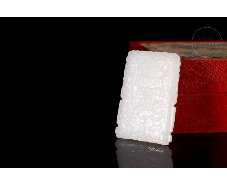 A jade plaque, rectangular with a cut-out rim, notable for its pristine white colour. It is decorated with fine relief motifs