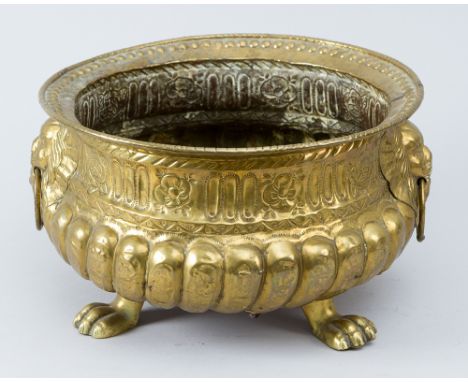 Dutch Basin, round bowl shape with chased ornaments fluted, on three lion feet and lion heads on the side, brass polished, da