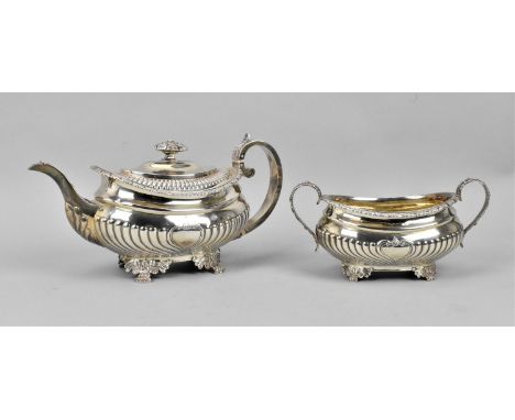 A George III silver teapot and sugar bowl by Joseph Angell I, London 1816, designed with part fluted bulbous bodies on paw fe