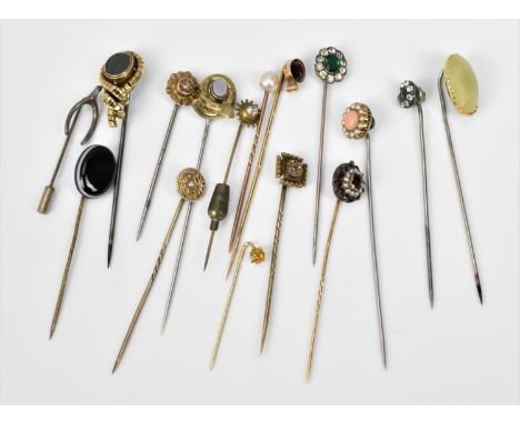 A collection of jewelled stick pins, to include Victorian and later gold ones with diamond accents, seed pearls, rubies, cora