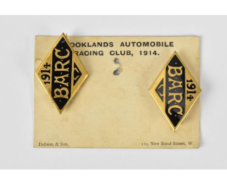 A pair of 1914 Brooklands Automobile Racing Club badges, on original card, with black enamel, numbers to the back reading No.