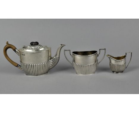 A late Victorian silver teapot and sugar bowl by Robert Pringle & Sons, London 1899, with part fluted bodies, together with a