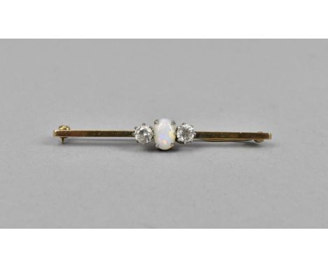 A 9ct gold opal and sapphire bar brooch, the central cabochon opal flanked with white sapphires either side, 5.7 cm long, 5 g