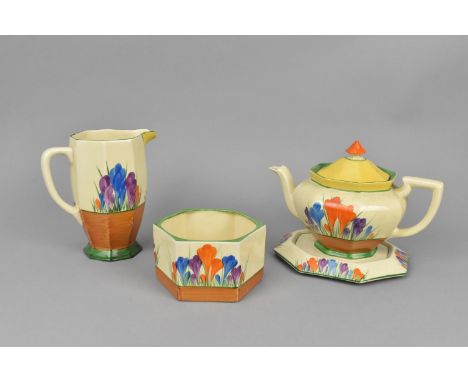 A Clarice Cliff Athens shape teapot in the Autumn Crocus pattern, together with an octagonal base, an Athens shape jug and an