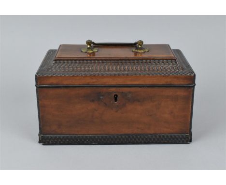 A George III mahogany tea caddy, of rectangular form with hinged brass carrying handle, the concave shaped lid opening to rev