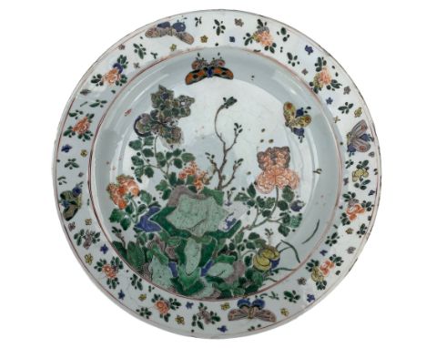 Chinese famille verte porcelain charger, Kangxi period, brightly enamelled with two butterflies in flight above chrysanthemum