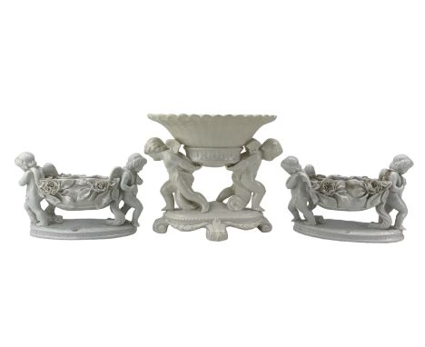 Pair of Victorian white glazed porcelain centrepieces, in the style of Moore Bros, each modelled as two winged cherubs holdin