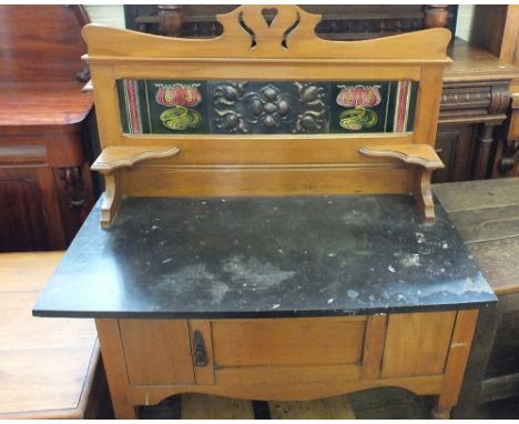 An Edwardian Satinwood and black marble washstand with Art Nouveau copper and tiled back