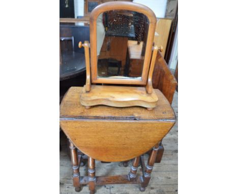 An oval Oak gate leg table and Satinwood dressing table mirror