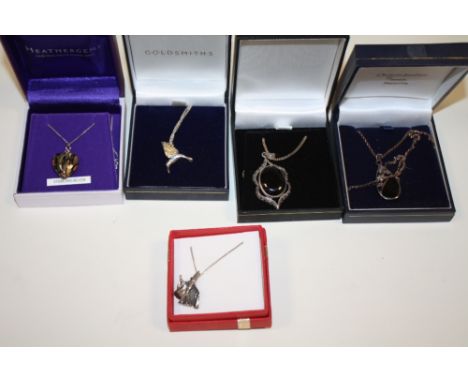 A COLLECTION OF STERLING SILVER PENDANTS ON CHAINS