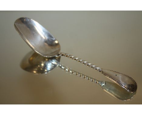 AN ANTIQUE SILVER CADDY SPOON BY GEORGE UNITE