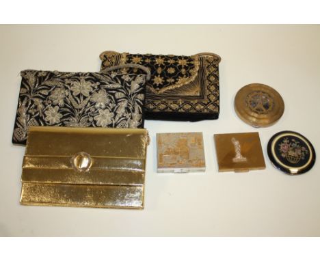FOUR VINTAGE LADIES POWDER COMPACTS, to include a circular enamel example with needlepoint panel to lid, together with three 