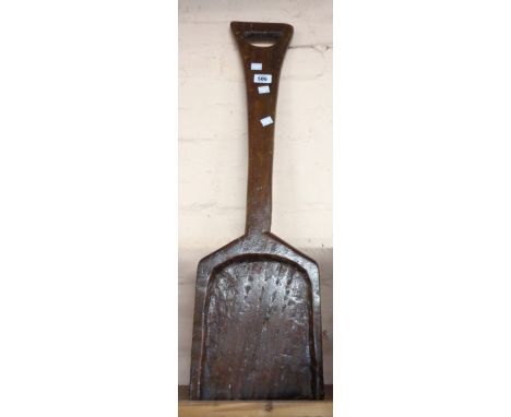 A vintage wooden mulch shovel