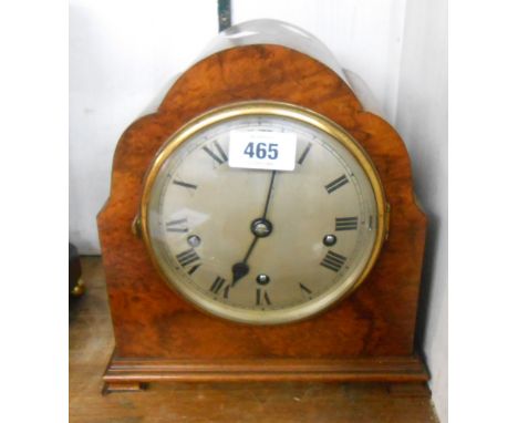 An early 20th Century burr walnut veneered cased mantel clock with silvered dial and eight day chiming movement