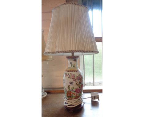 A Chinese style porcelain table lamp with transfer printed decoration and hand painted highlighting