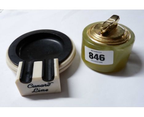 An Art Deco black and cream Bakelite ashtray made for the Cunard line - sold with a vintage onyx table lighter