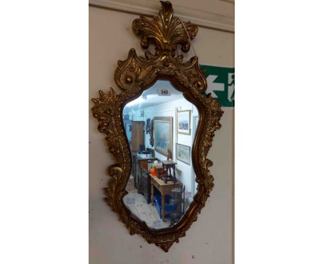 A vintage ornate gilt resin framed wall mirror with shaped plate - strap repair to pediment