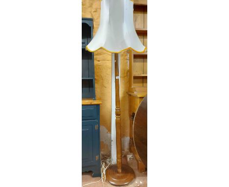 A vintage stained wood standard lamp with fluted pillar and shade